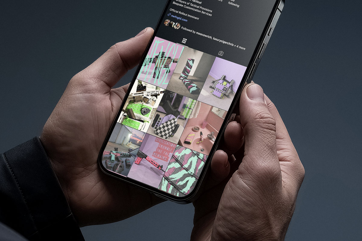 A hand holding a smartphone showing the NWFNGLD Instagram profile grid of product photos.