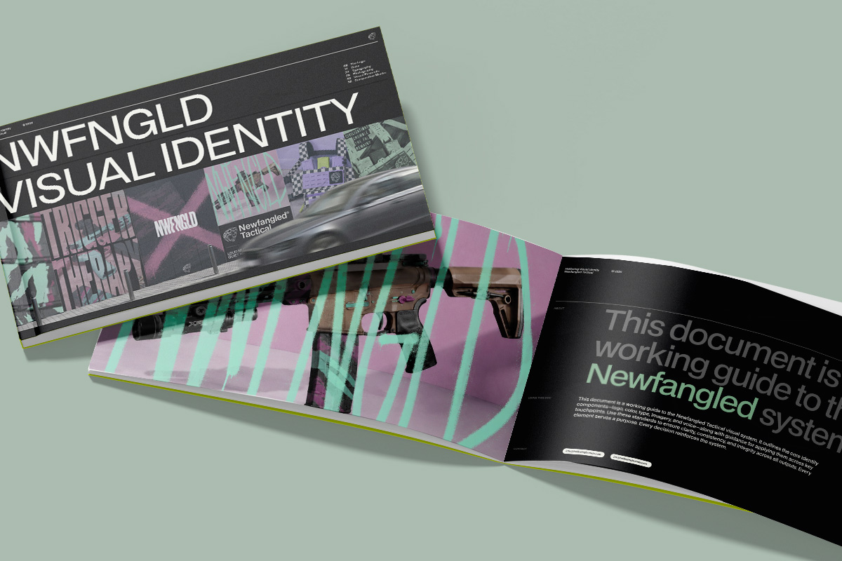 A printed "NWFNGLD Visual Identity" brand book shown open on a sage-green surface.