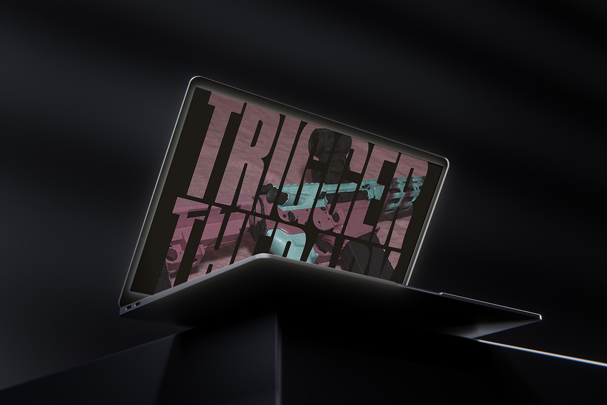 A laptop tilted on a dark pedestal showing the Newfangled Tactical website with the hero that says "Trigger Therapy".